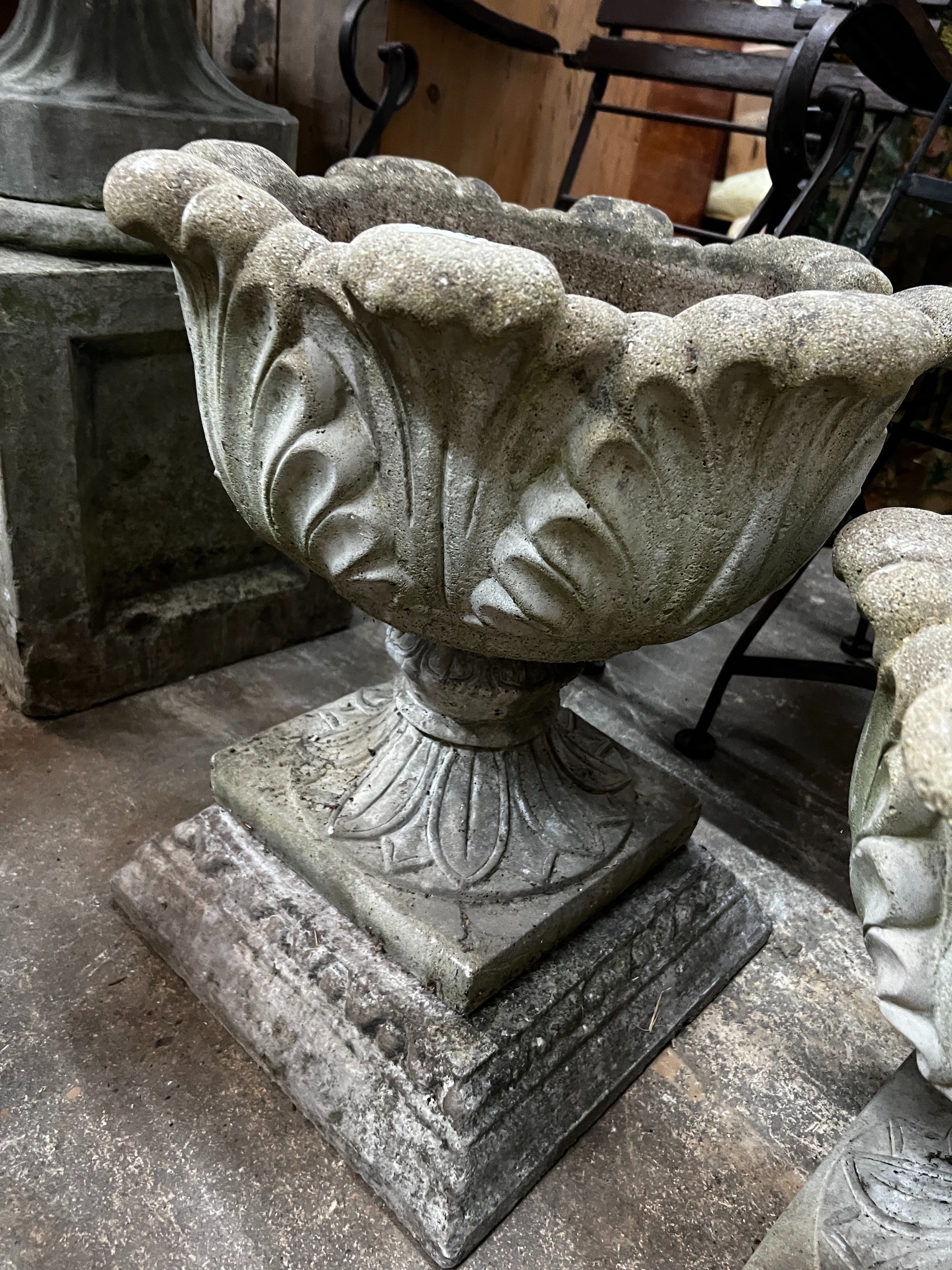 Three circular reconstituted stone garden urns, the largest diameter 48cm, height 55cm